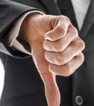 Business man showing a thumb down gesture.
