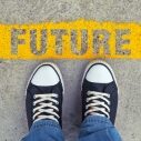 Male sneakers on the asphalt road with yellow line and title Future. Step into the future.