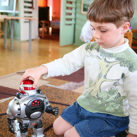 sad child alone with robot in kindergarten
